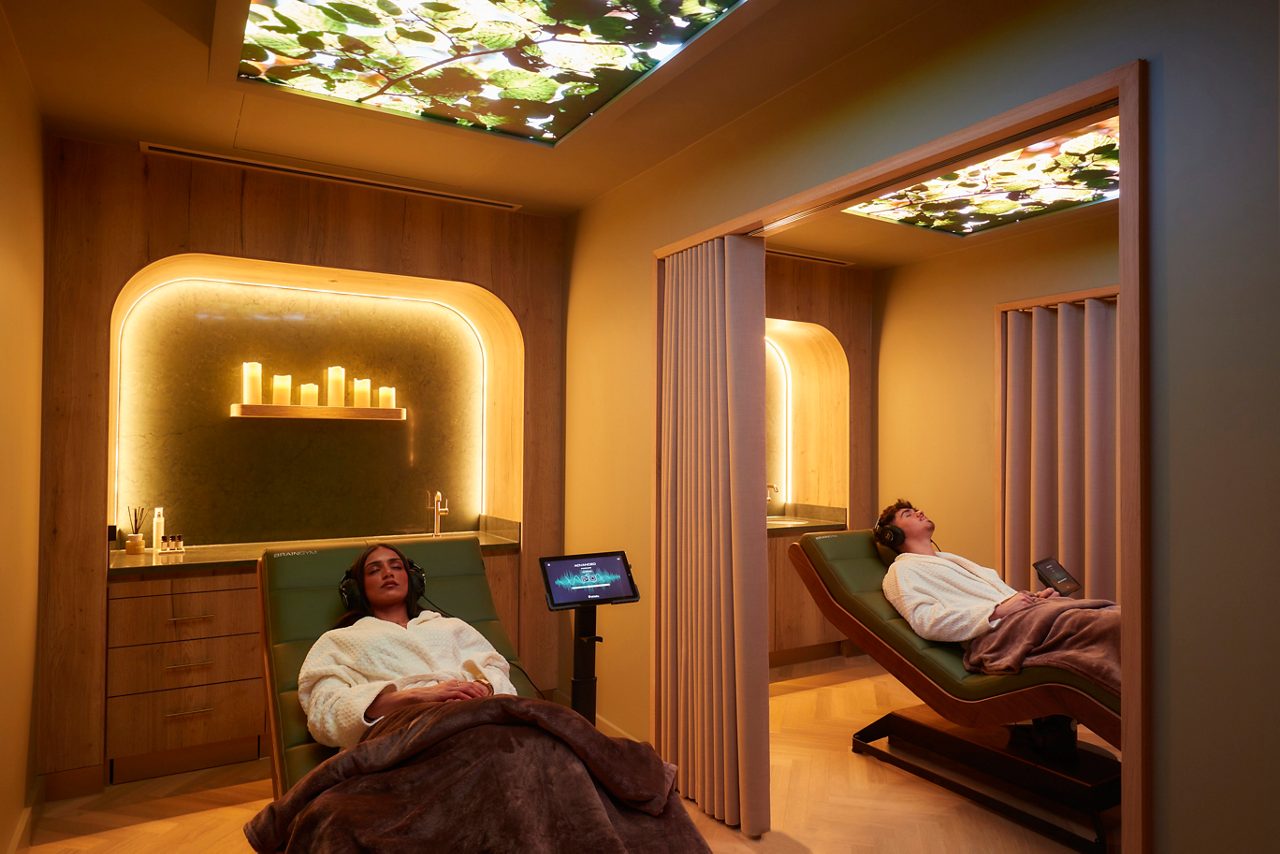 Two people laid back enjoying the environment of the Forest Serenity Suite.