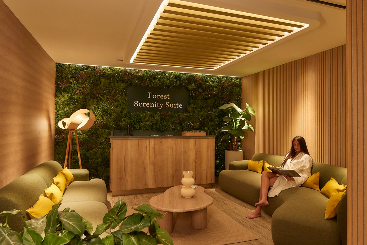 Woman sitting in the Forest Serenity Suite.