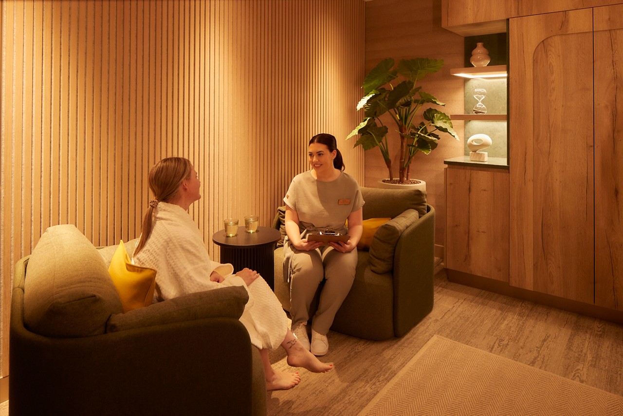 Therapist talking to client in spa room