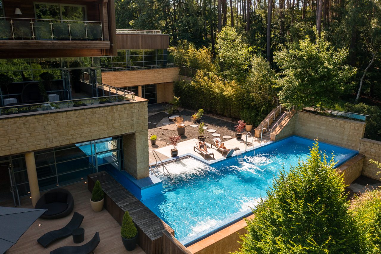Outdoor pool surrounded by the forest.