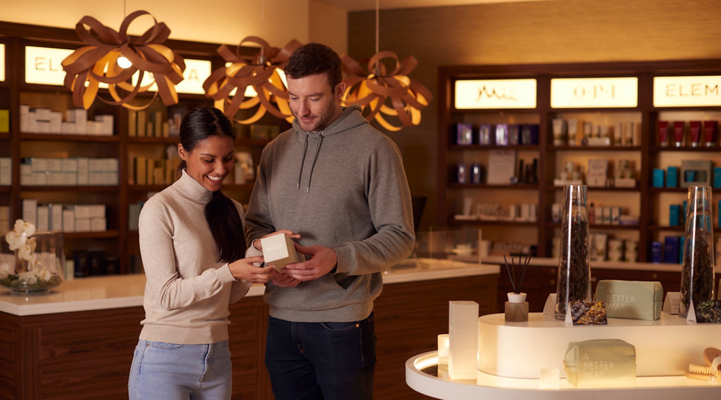 Couple browsing the spa and beauty products available inside the Aqua Sana Boutique.