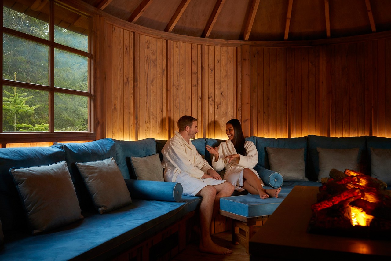 Couple snuggled up inside the Scandinavian Snug.