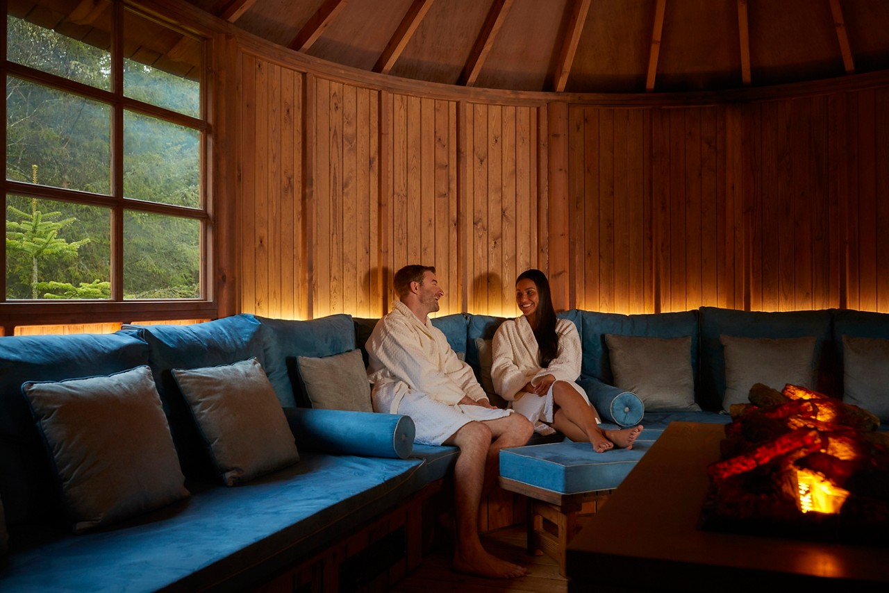 Couple snuggled up inside the Scandinavian Snug.