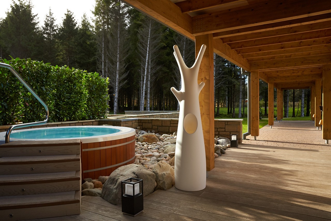 Outdoor hot tub with views out to the forest.