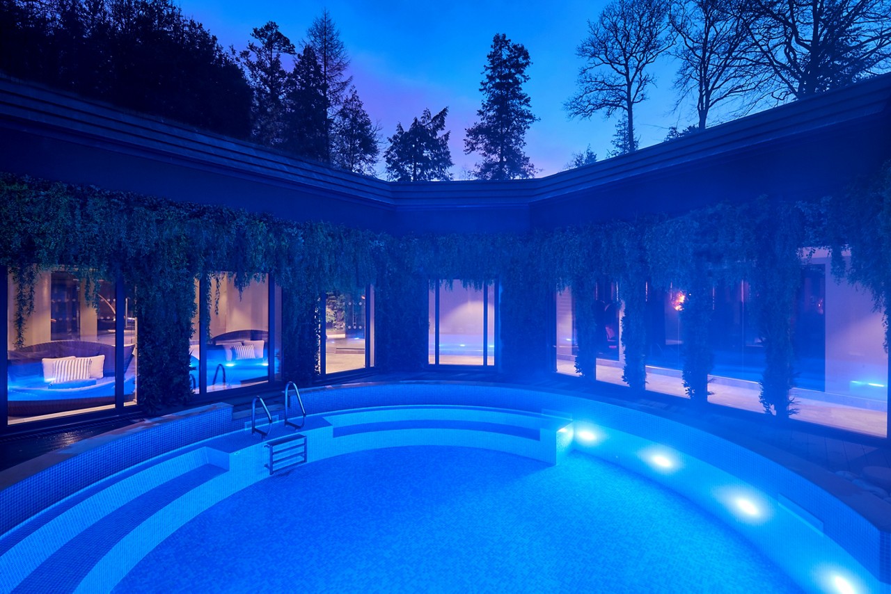 Circular Outdoor Pool surrounded by hanging plants.