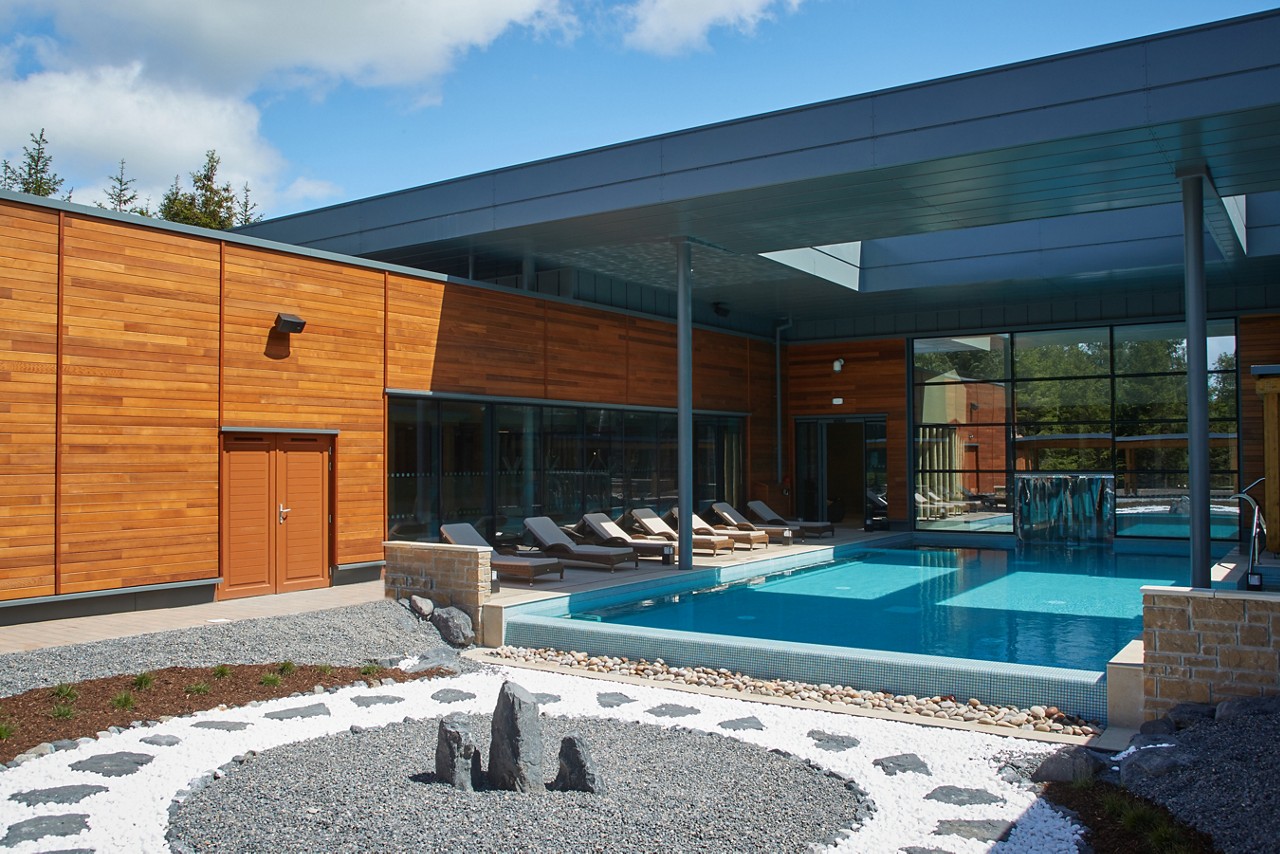 Stone feature at the end of a glistening Outdoor Pool.