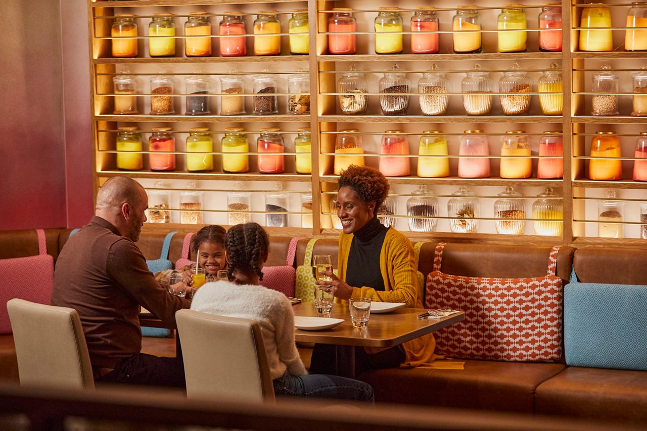 Family eating around a table in Rajinda's.