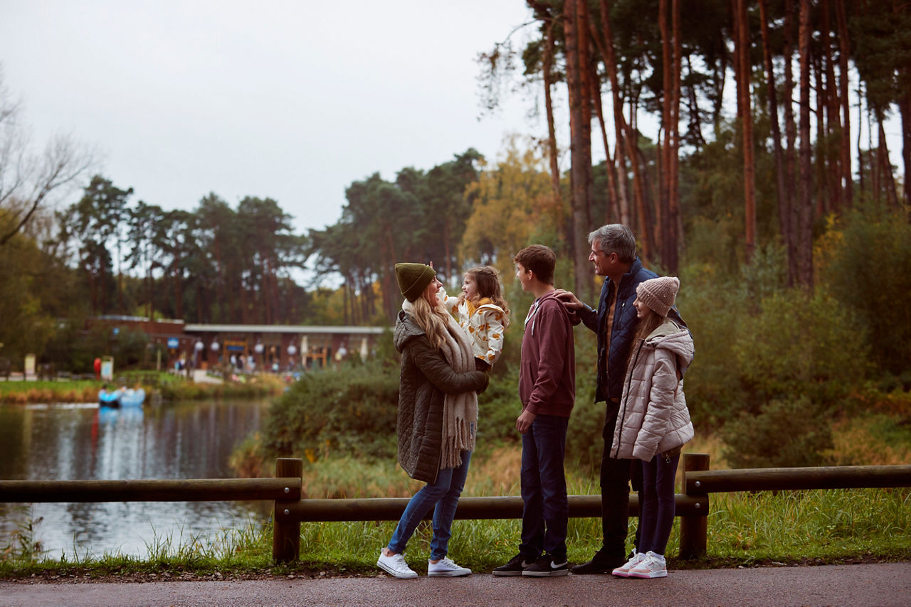 A family waving at each other on the boat hire activity.
