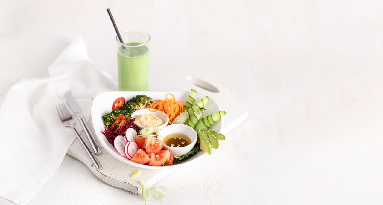 Refreshing Buddah Bowl served with a green smoothie.
