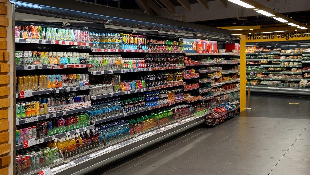 Inside the Parc Market shop a row with shelves of drink options