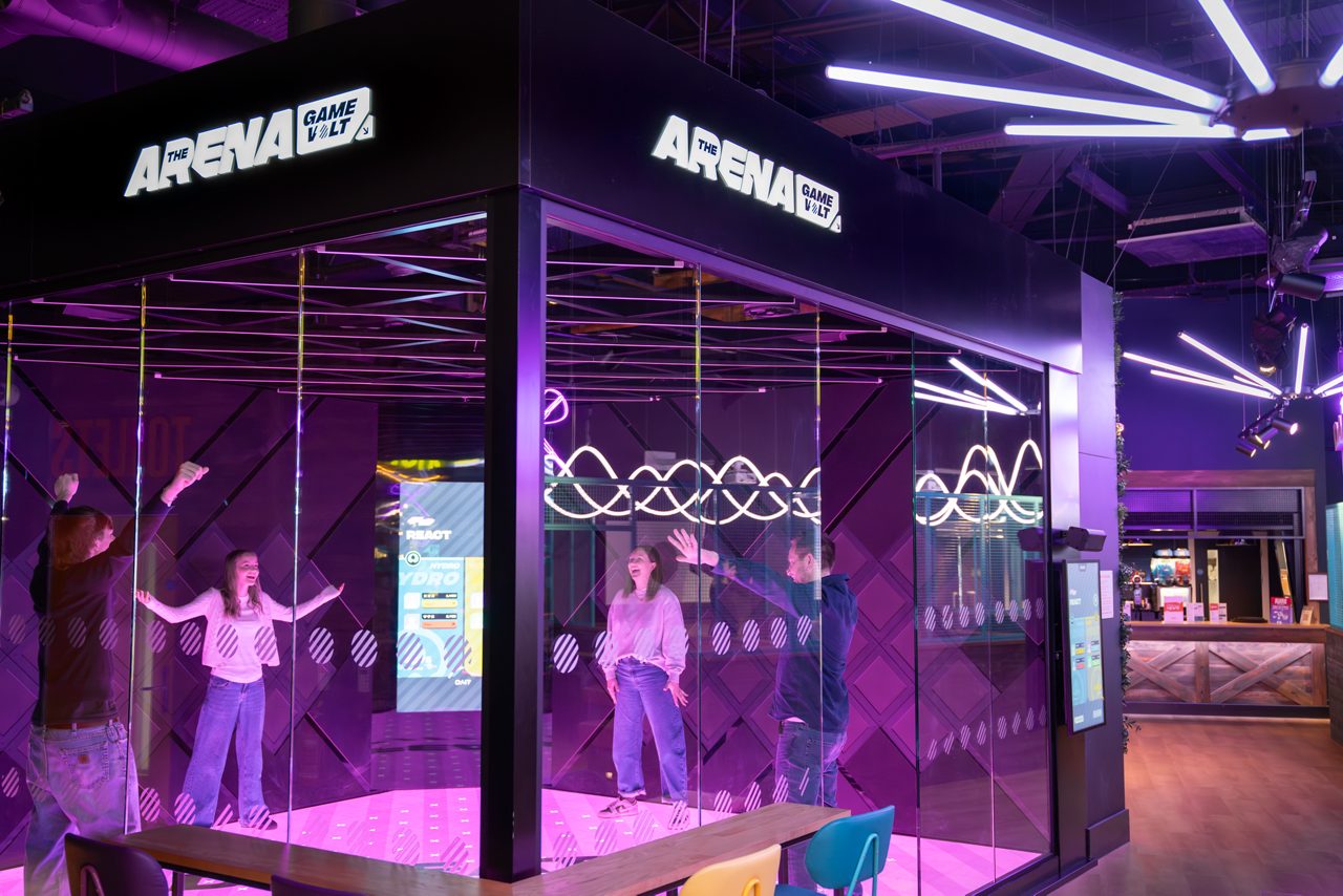A view of someone playing inside the clear cube Arena. 
