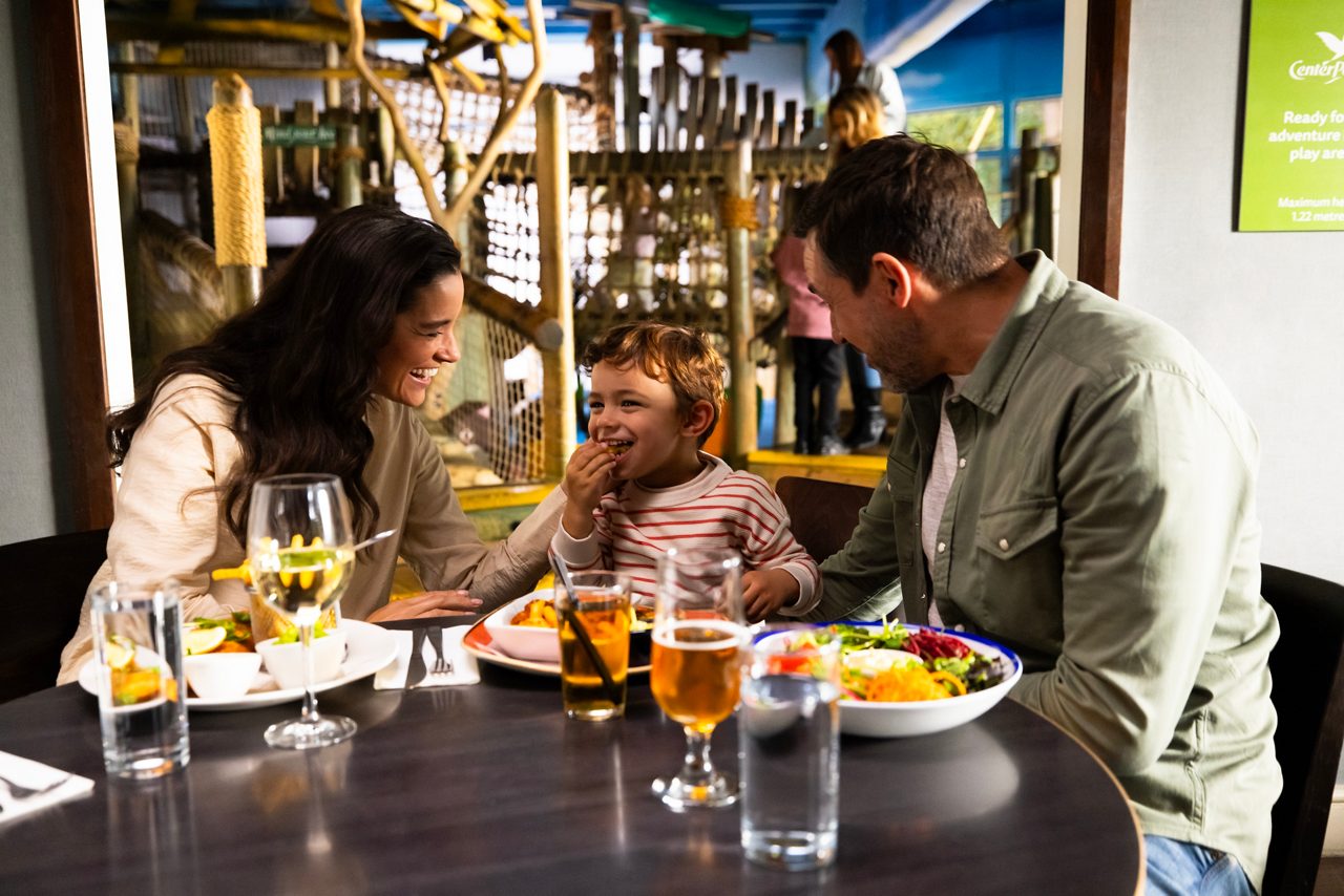 A family eating food at Huck's american bar and grill restaurant.