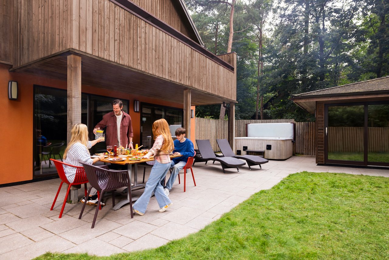 Adults Walking by a lodge at Center Parcs