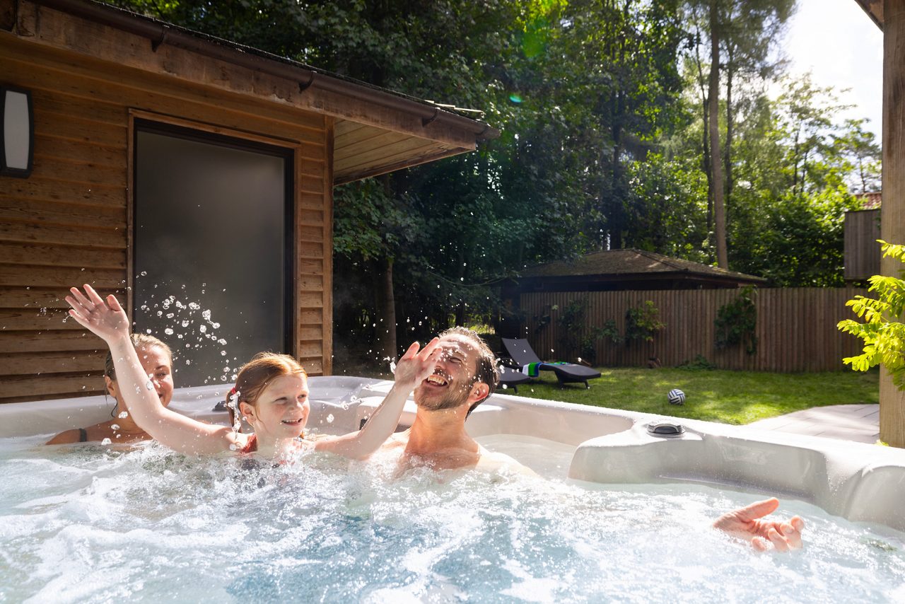 Family sat in a hot tub at Center Parcs