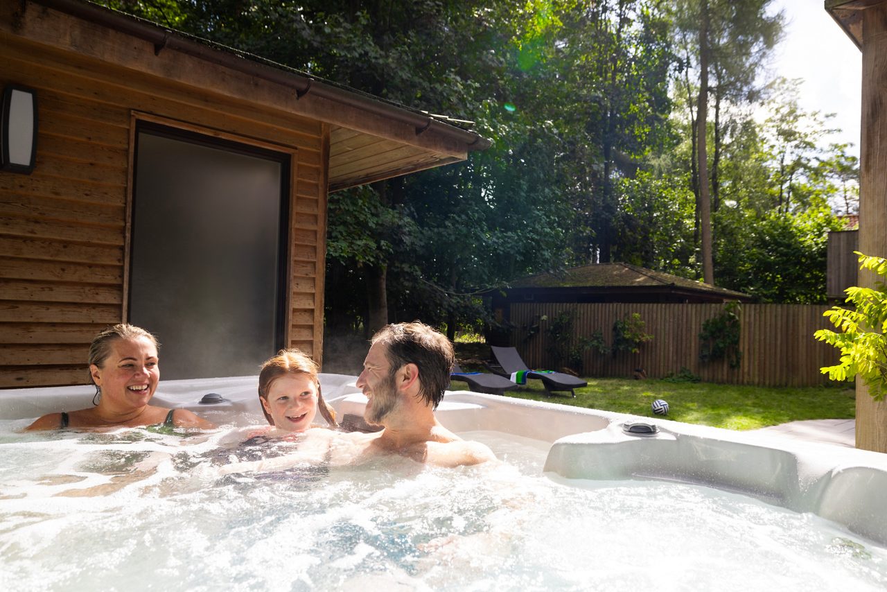 Family sat in a hot tub at Center Parcs