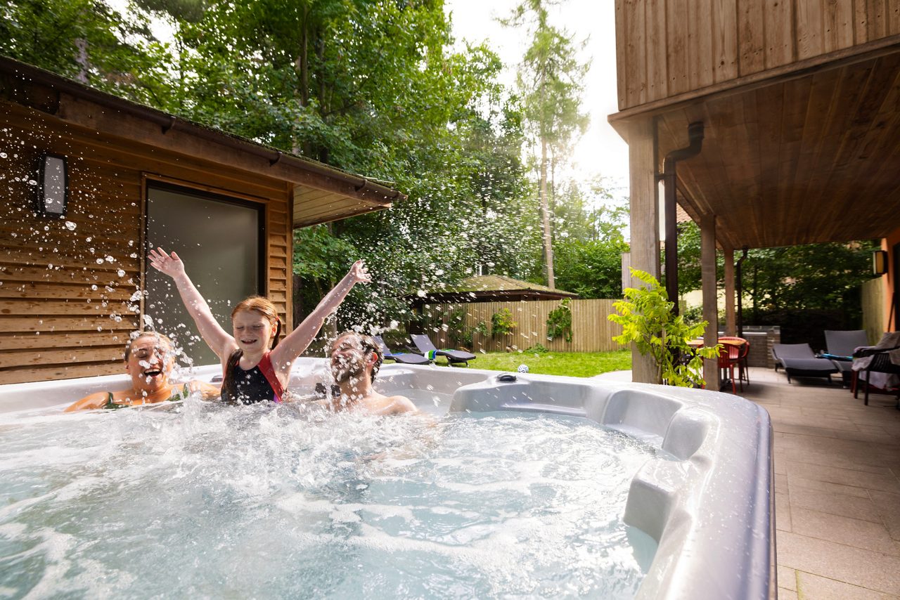 Family sat in a hot tub at Center Parcs
