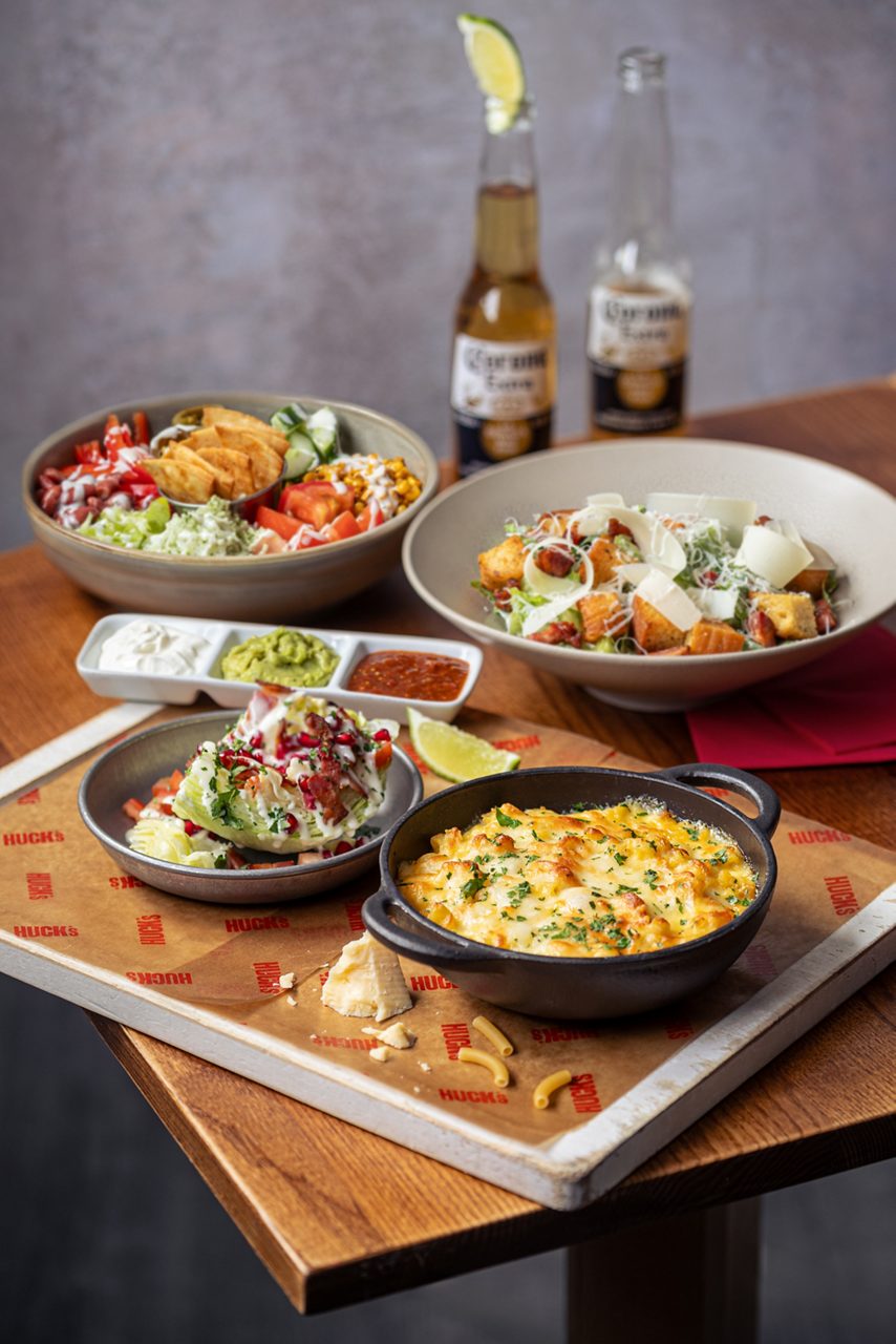 array of different food dishes from nachos to salads 