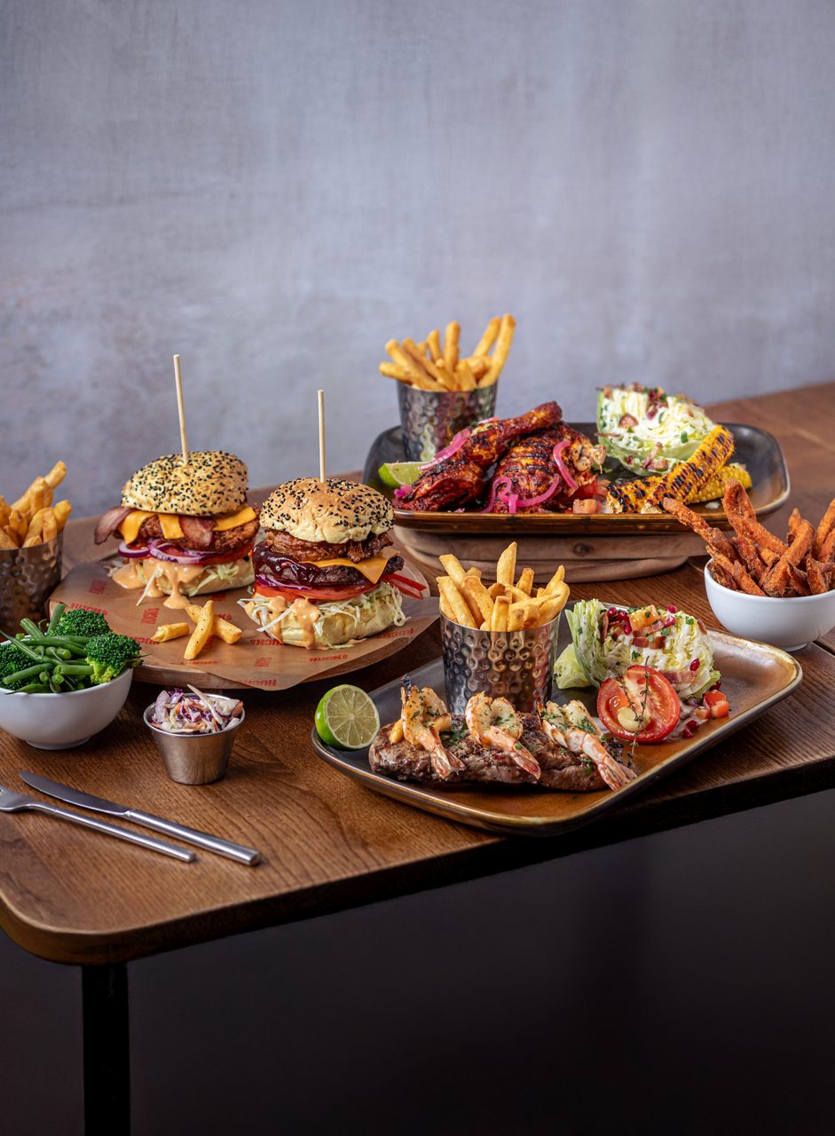 Selection of dishes from the Huck's menu including, crispy fries, loaded burgers and wings.