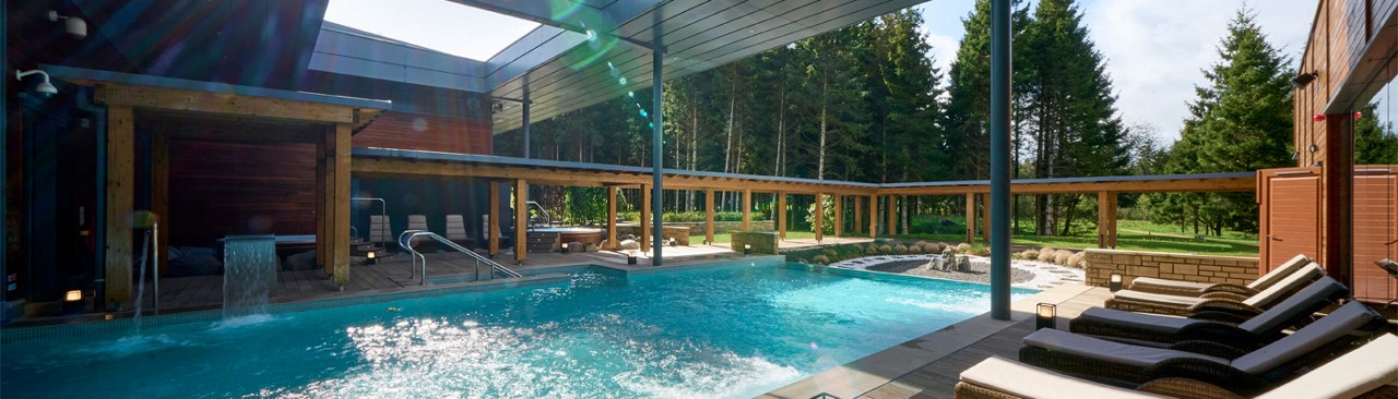 Woman soaking in an outdoor hot tub.