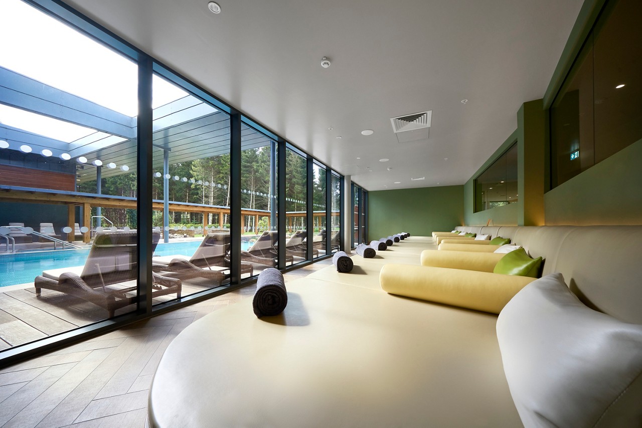 Curved lounging area with views out to the Outdoor Pool.