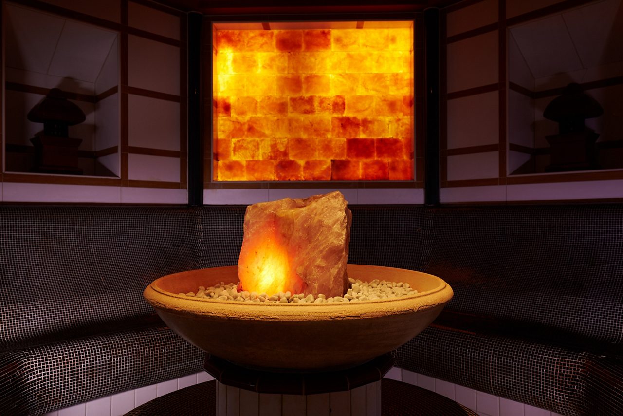 Curved bench seating around a glowing salt centrepiece.