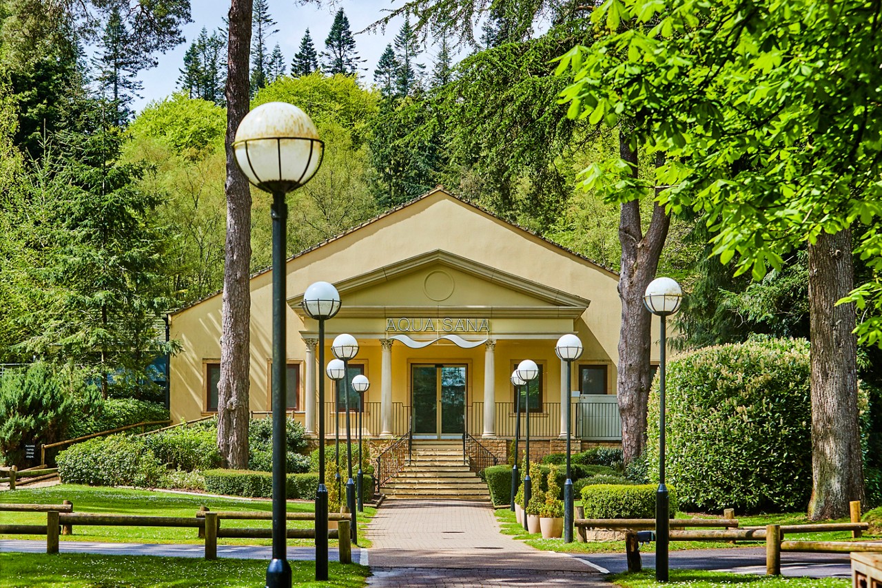 Woman sat on the bed in her spa suite. 