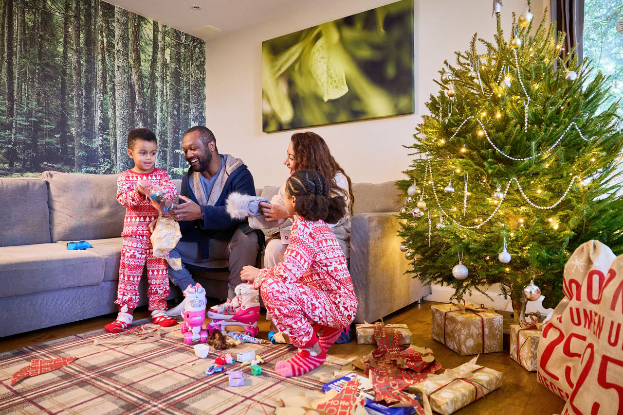 A family opening presents in their lodge on Christmas day.