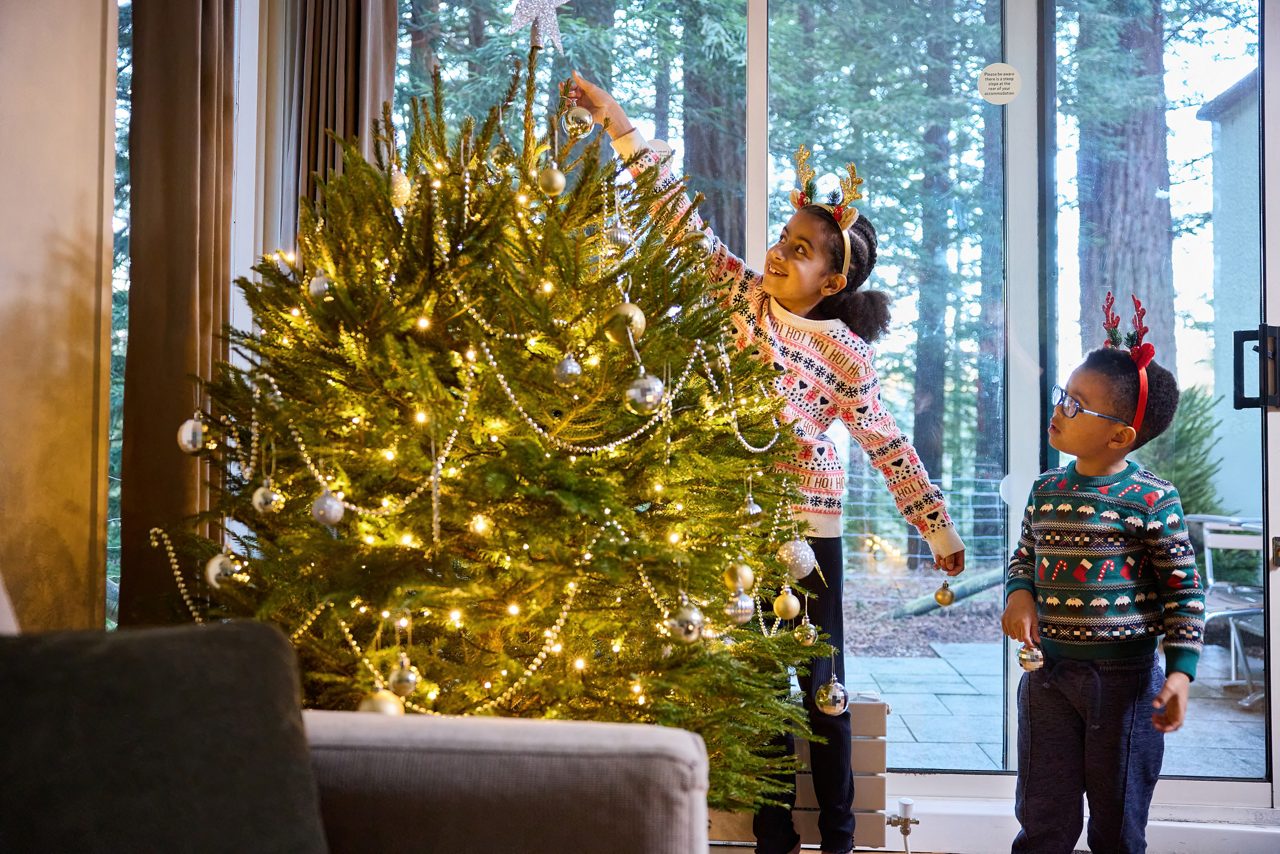 children decorating christmas tree