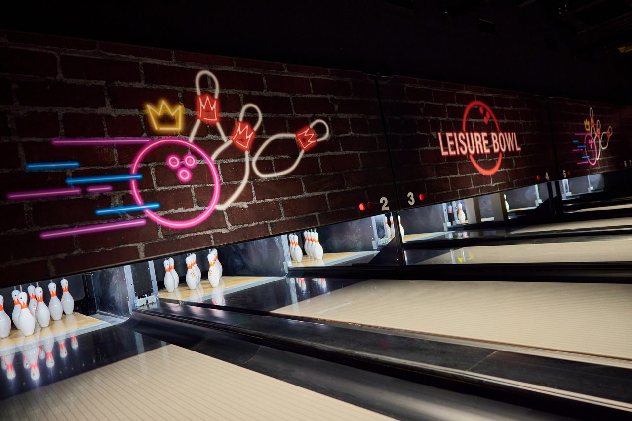A view of the bowling lanes with pins in place. 