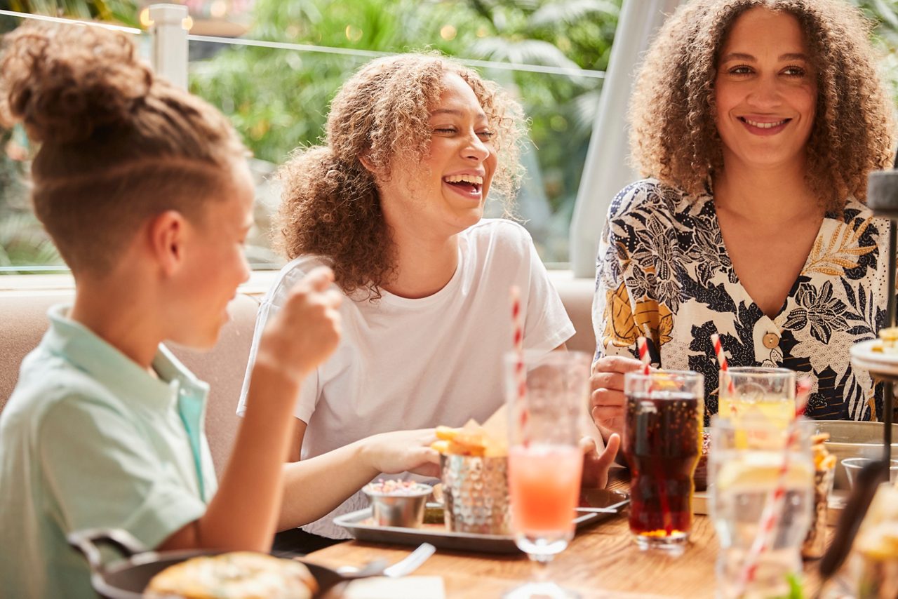 A family eating food at Huck's american bar and grill restaurant.