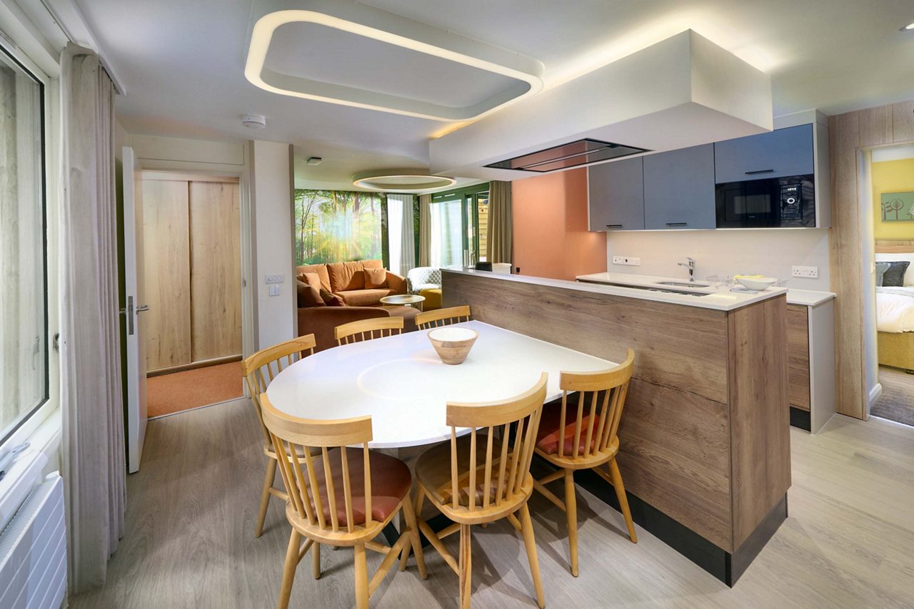 A view of the kitchen area and dining table. 