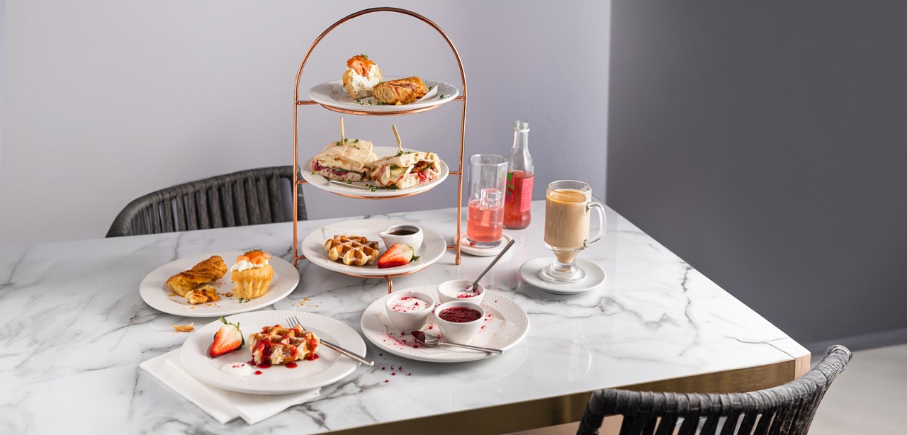 Stacked brunch served with a pot of tea.