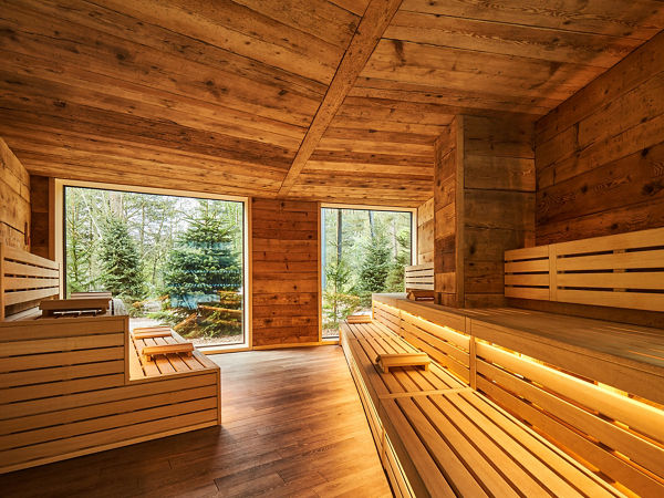 Nordic Sauna with soft lighting and forest views.