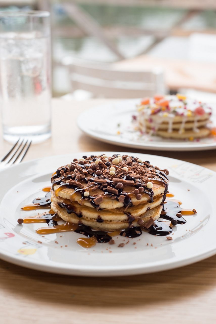 Chocolate pancake stack with drizzle.