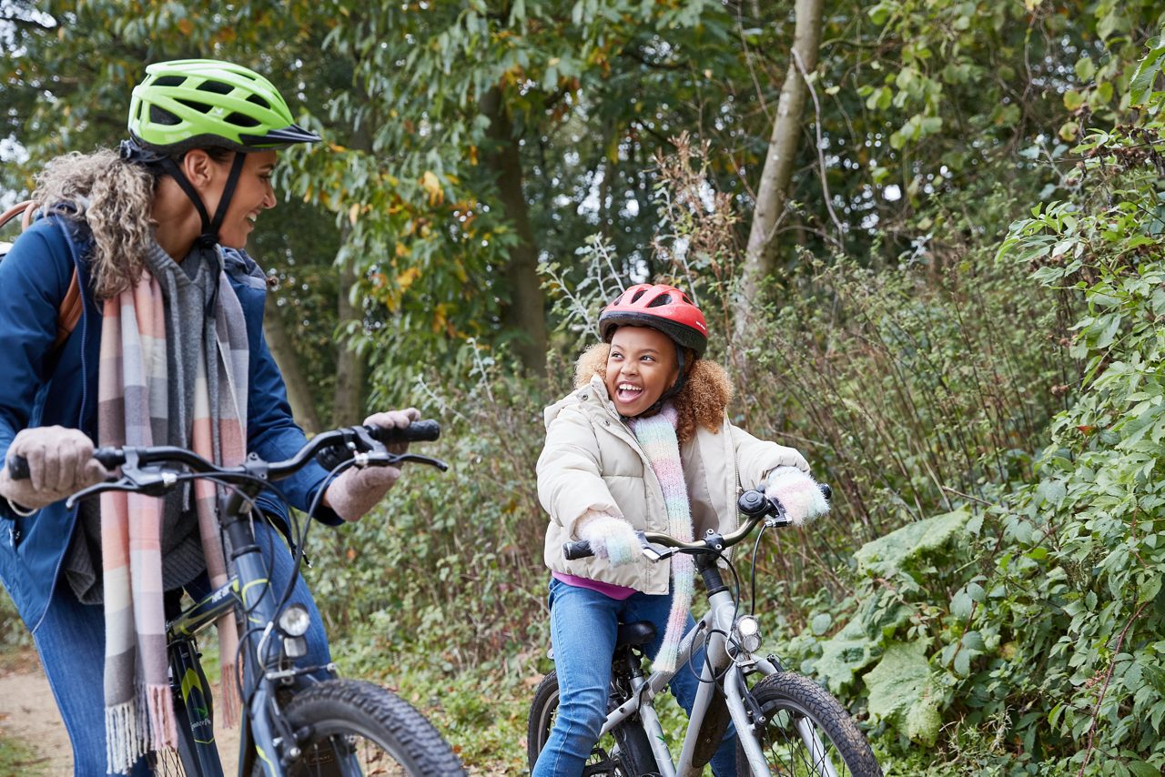 family on a bike ride with school age child