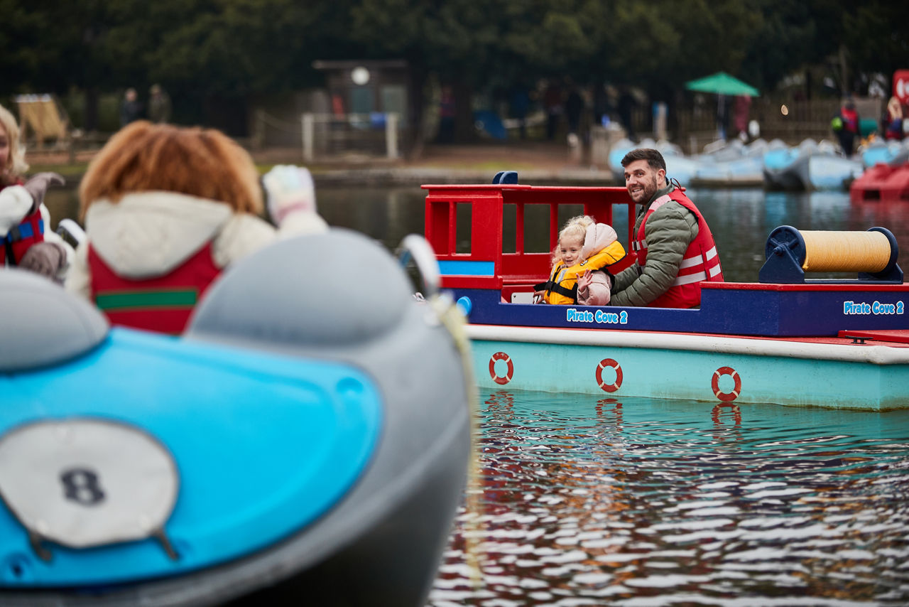 A family talking to an Christmas elf