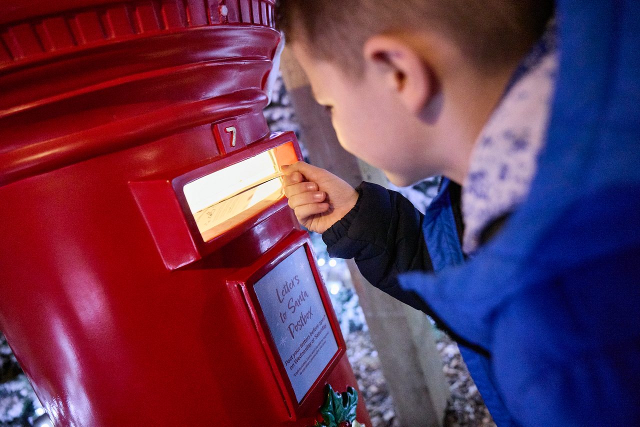 Young girl looking at a letter with an elf.