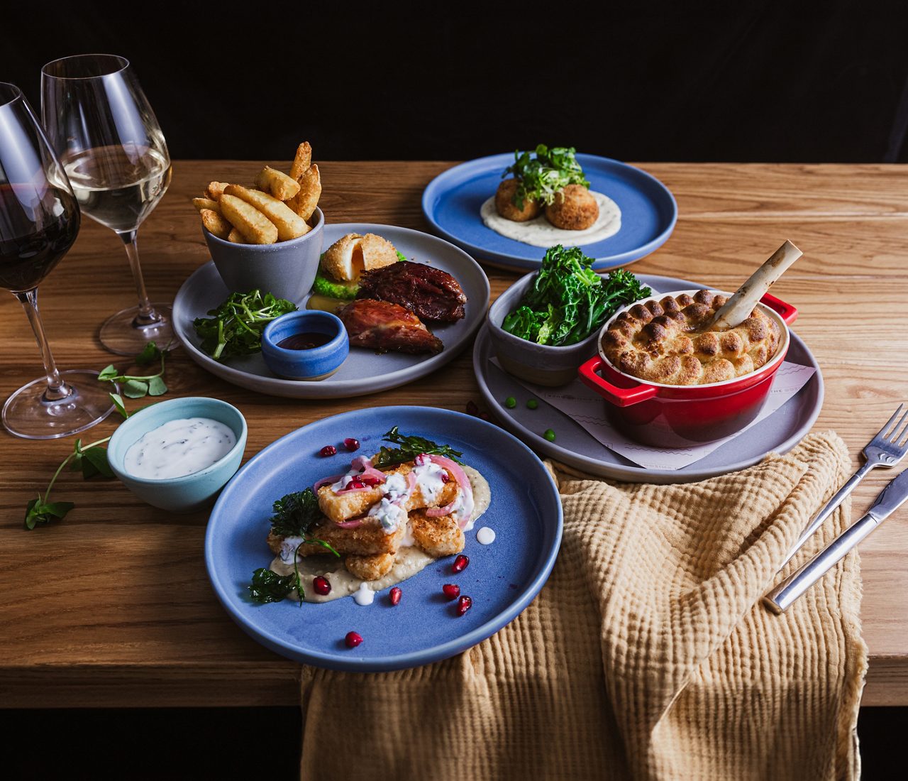 a collection of different dishes on blue plates at The Dozing Duck