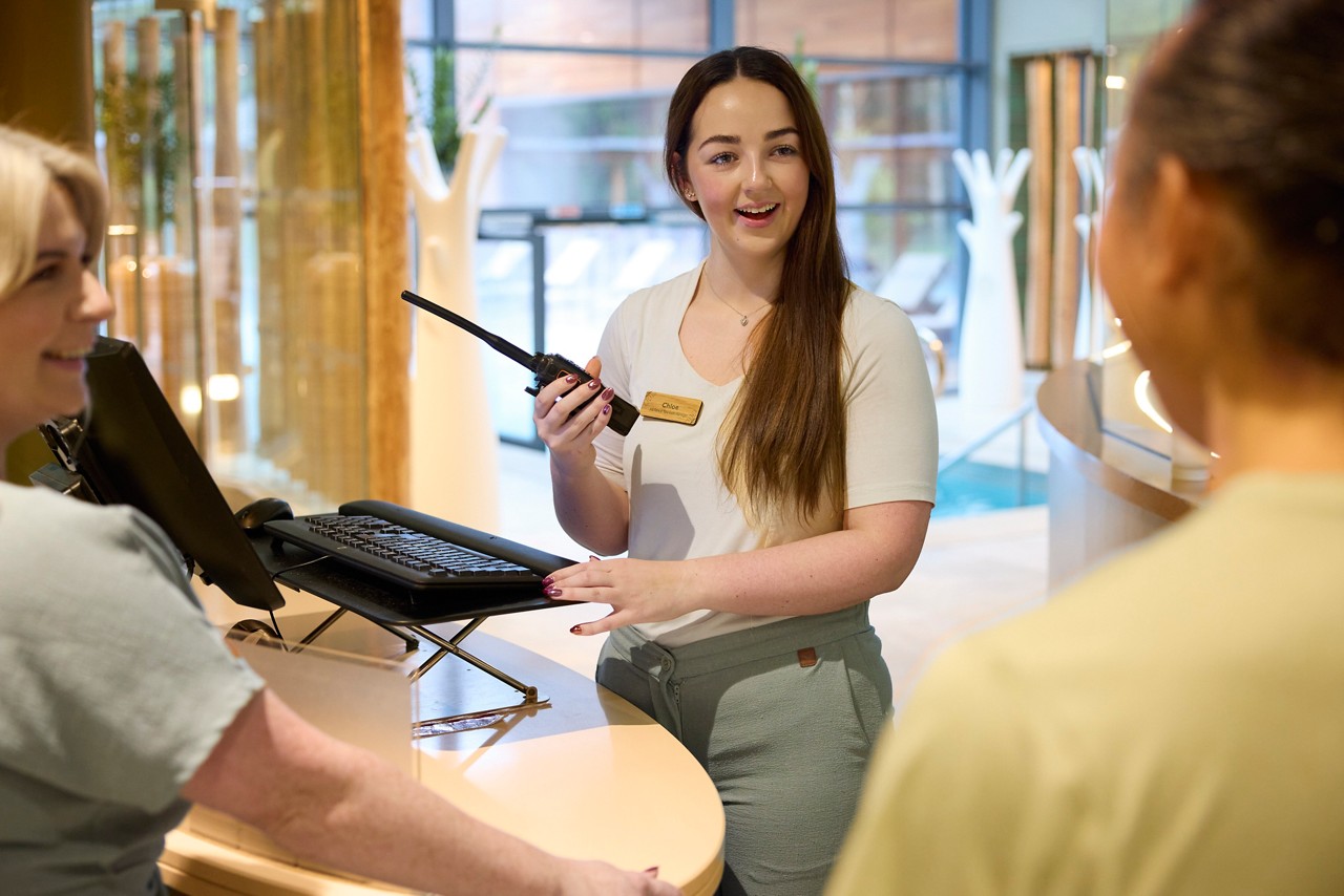 Woman sat on the bed in her spa suite. 
