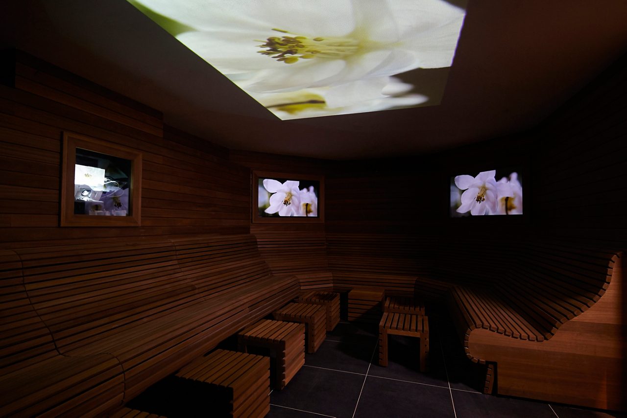 Sensory room with floral images projected on the ceiling.