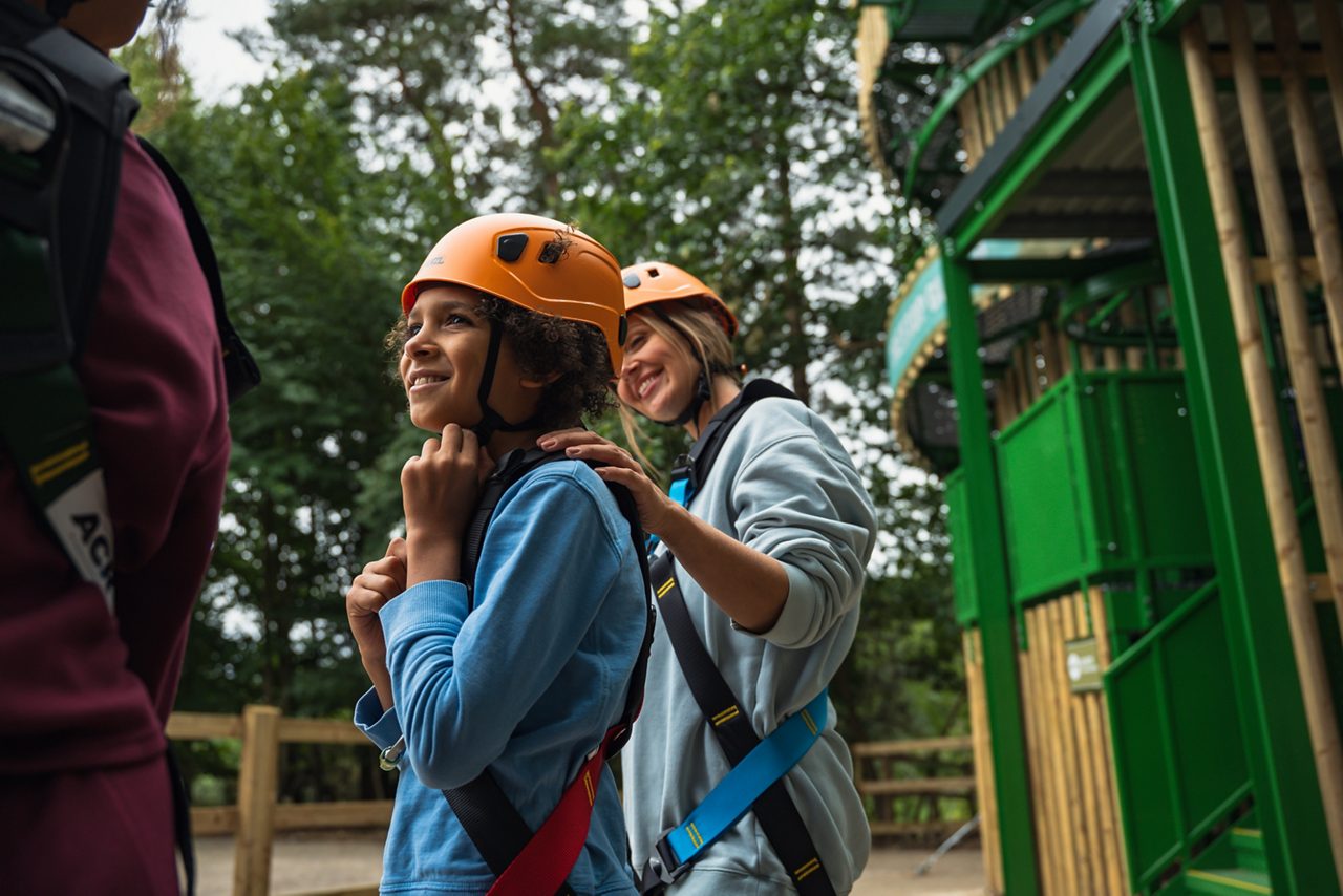 child getting prepared for treetop glider