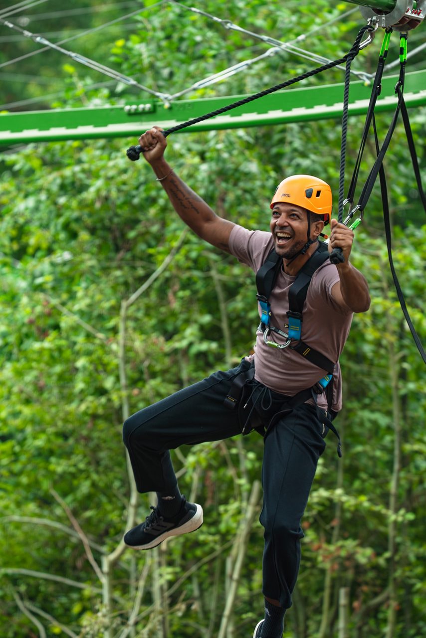 man swinging through the trees