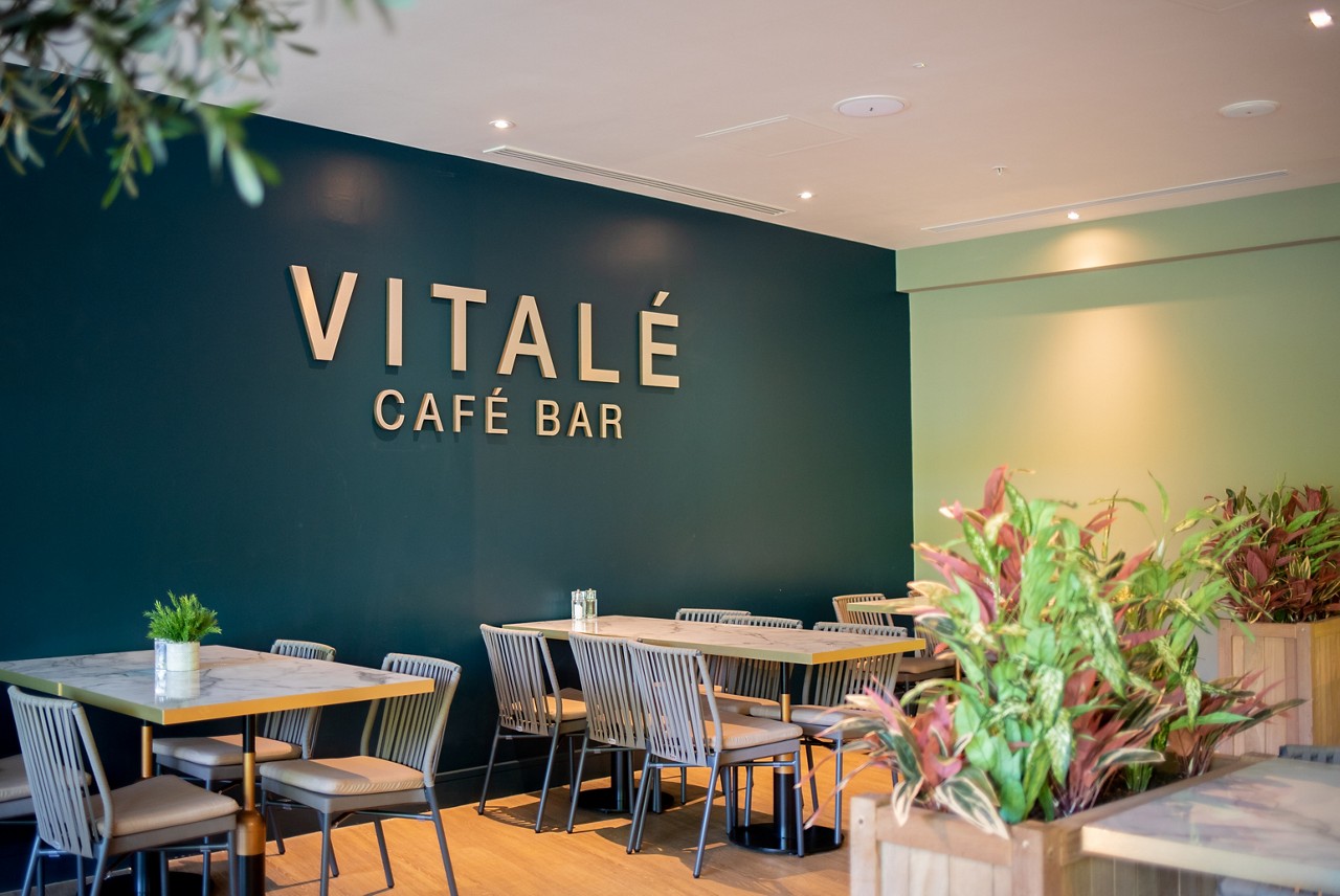 Woman sat on the bed in her spa suite. 