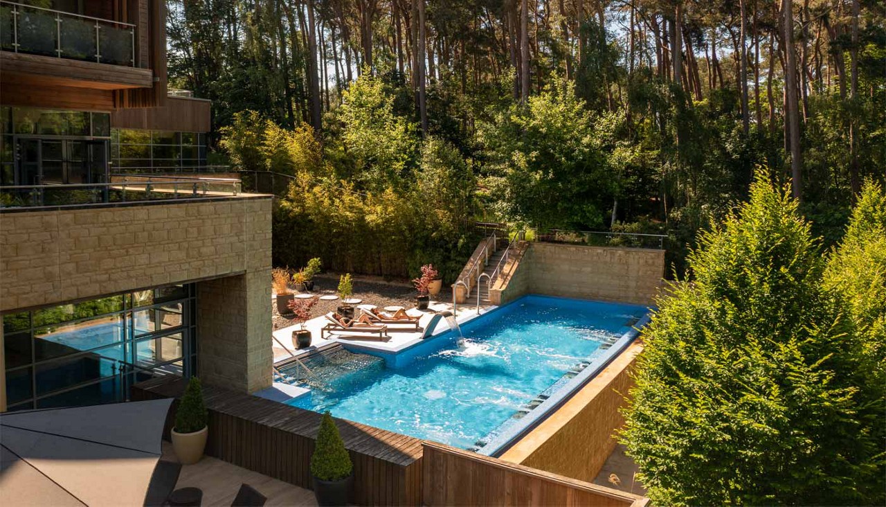 Drone shot of an outdoor pool and terrace area.
