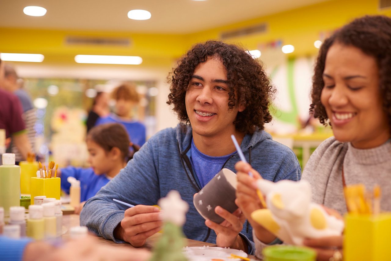 A group painting festive themed pottery in the Pottery Painting Studio.