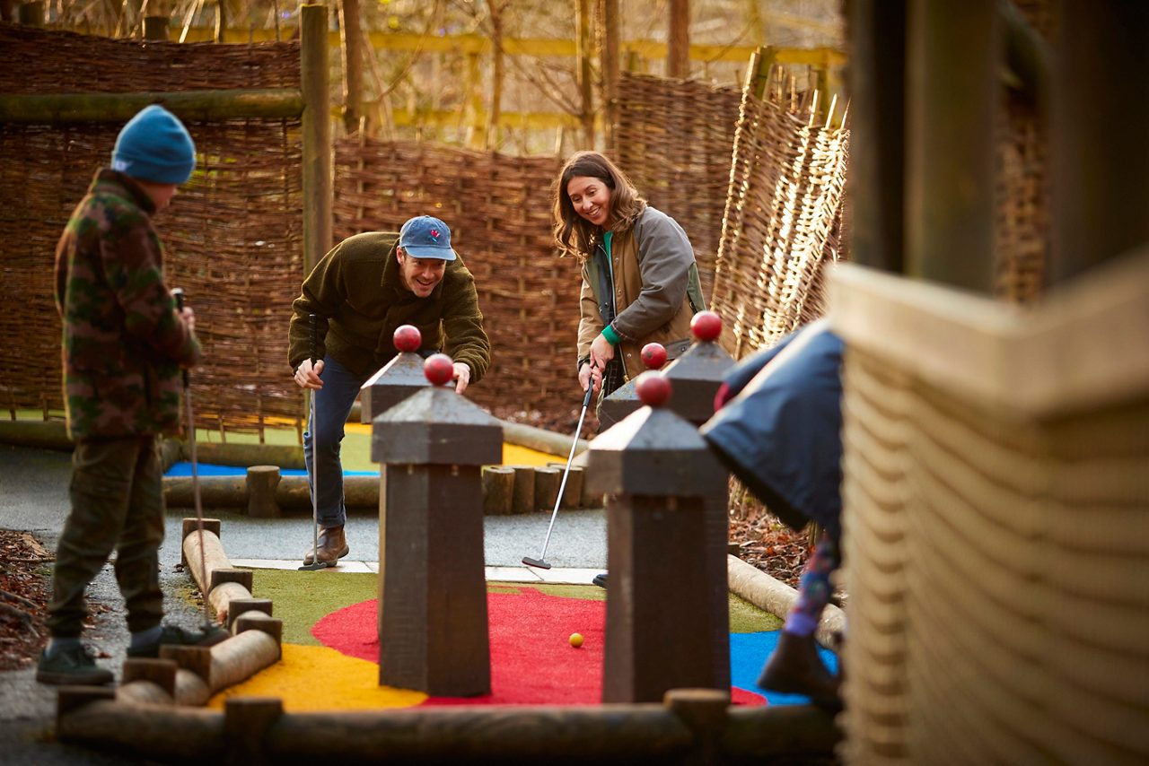 family playing mini golf