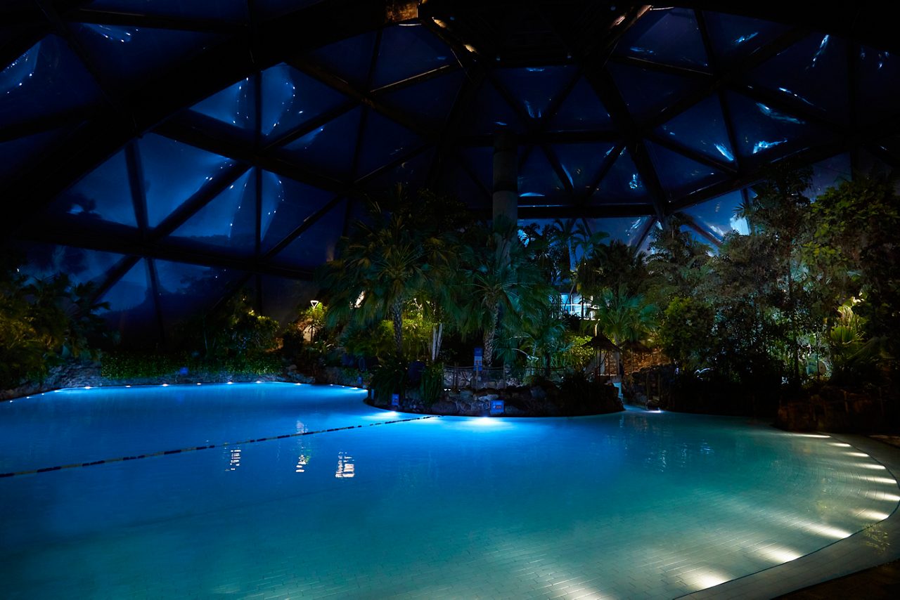The inside of the Subtropical Swimming Paradise, lit up at night time. 
