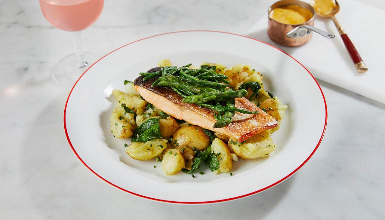 Salmon on a bed of potatoes.