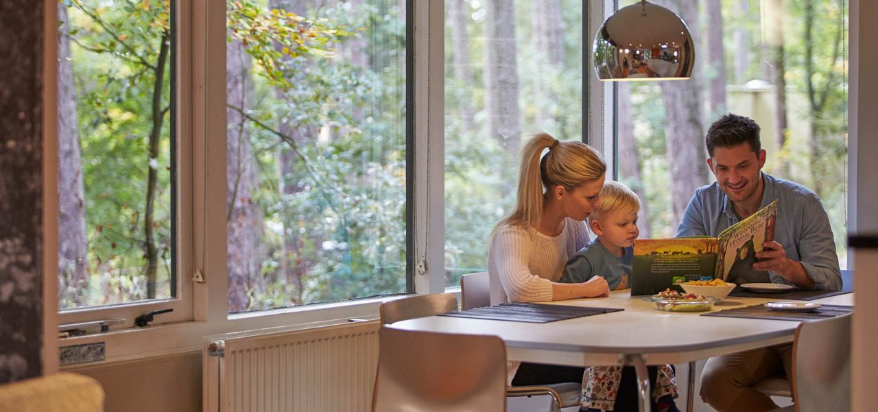 A family reading together in their lodge