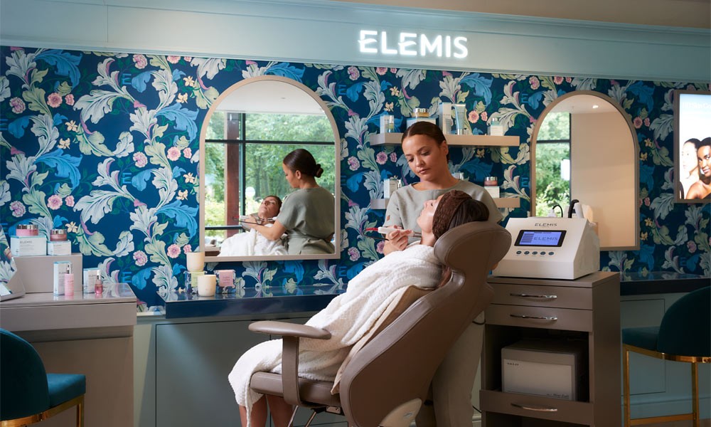Woman sat in a reclined chair having and ELEMIS facial using BIOTEC devices.